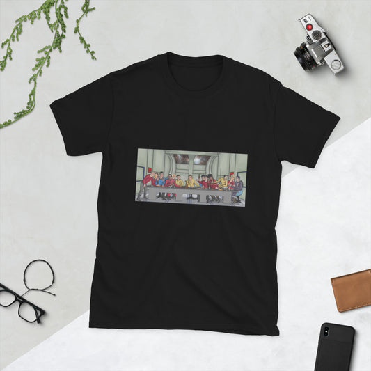 A black t-shirt with a rectangle image in the front centre that depicts The Last Supper painting by Michelangelo but done in cartoon style with the crew and cast of Star Trek the Original series depicted as the apostles and Jesus