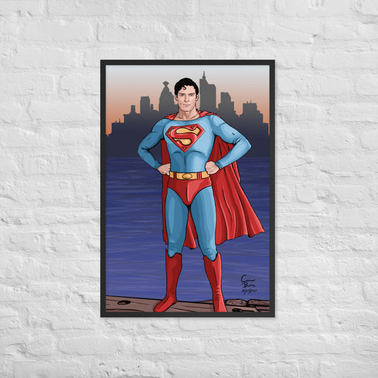 Semi realistic caricature of Christopher Reeve Superman standing on a dock with Metropolis in the background. The picture is framed with a black frame and is hanging on a white brick wall.