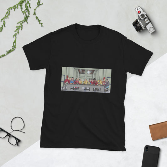 A black t-shirt with a rectangle image in the front centre that depicts The Last Supper painting by Michelangelo but done in cartoon style with the crew and cast of Star Trek the Original series depicted as the apostles and Jesus  