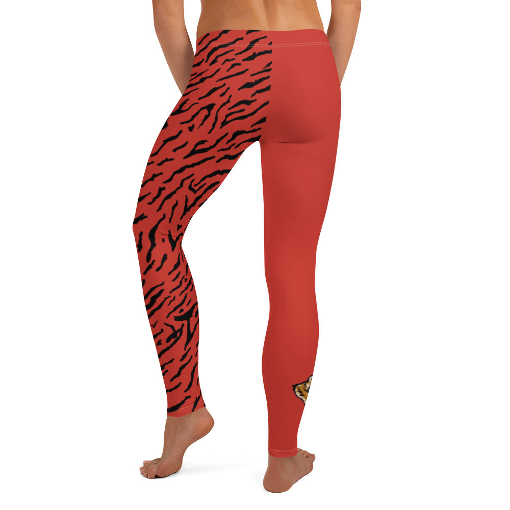 Female model wearing Red leggings with a hand drawn tiger on the right lower leg and black tiger print covers the left leg and waist fully on the left side, front and back.