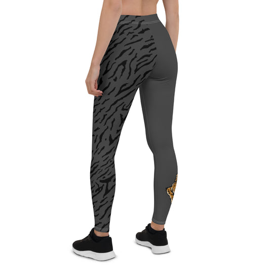 Female model wearing grey leggings with a hand drawn tiger on the right lower leg and black tiger print covers the left leg and waist fully on the left side, front and back.