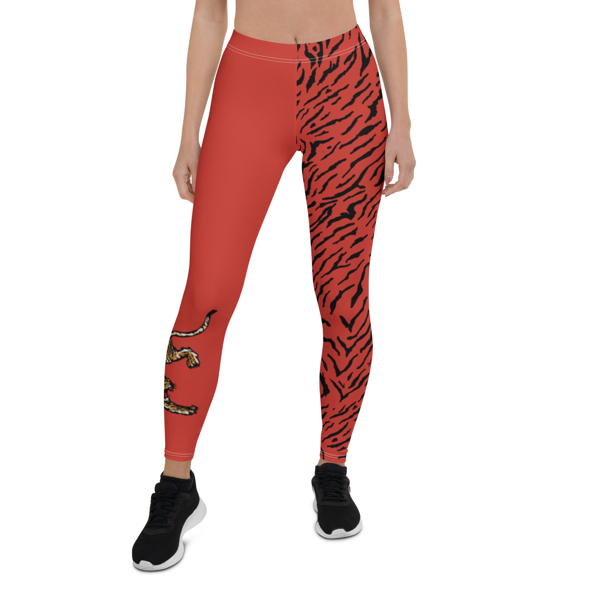 Female model wearing Red leggings with a hand drawn tiger on the right lower leg and black tiger print covers the left leg and waist fully on the left side, front and back.