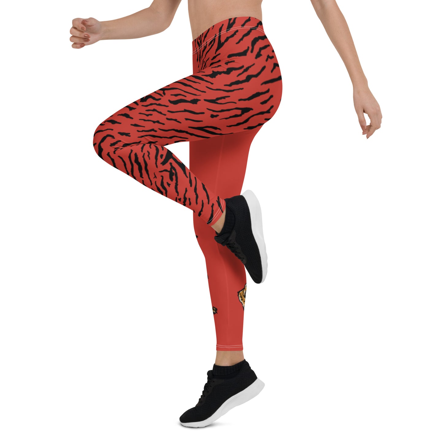 Female model wearing Red leggings with a hand drawn tiger on the right lower leg and black tiger print covers the left leg and waist fully on the left side, front and back.