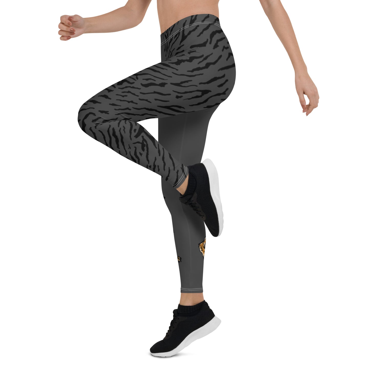 Female model wearing grey leggings with a hand drawn tiger on the right lower leg and black tiger print covers the left leg and waist fully on the left side, front and back.