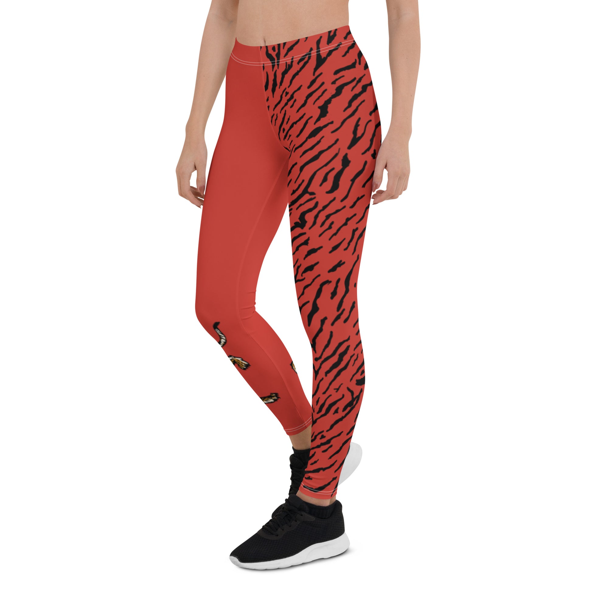 Female model wearing Red leggings with a hand drawn tiger on the right lower leg and black tiger print covers the left leg and waist fully on the left side, front and back.