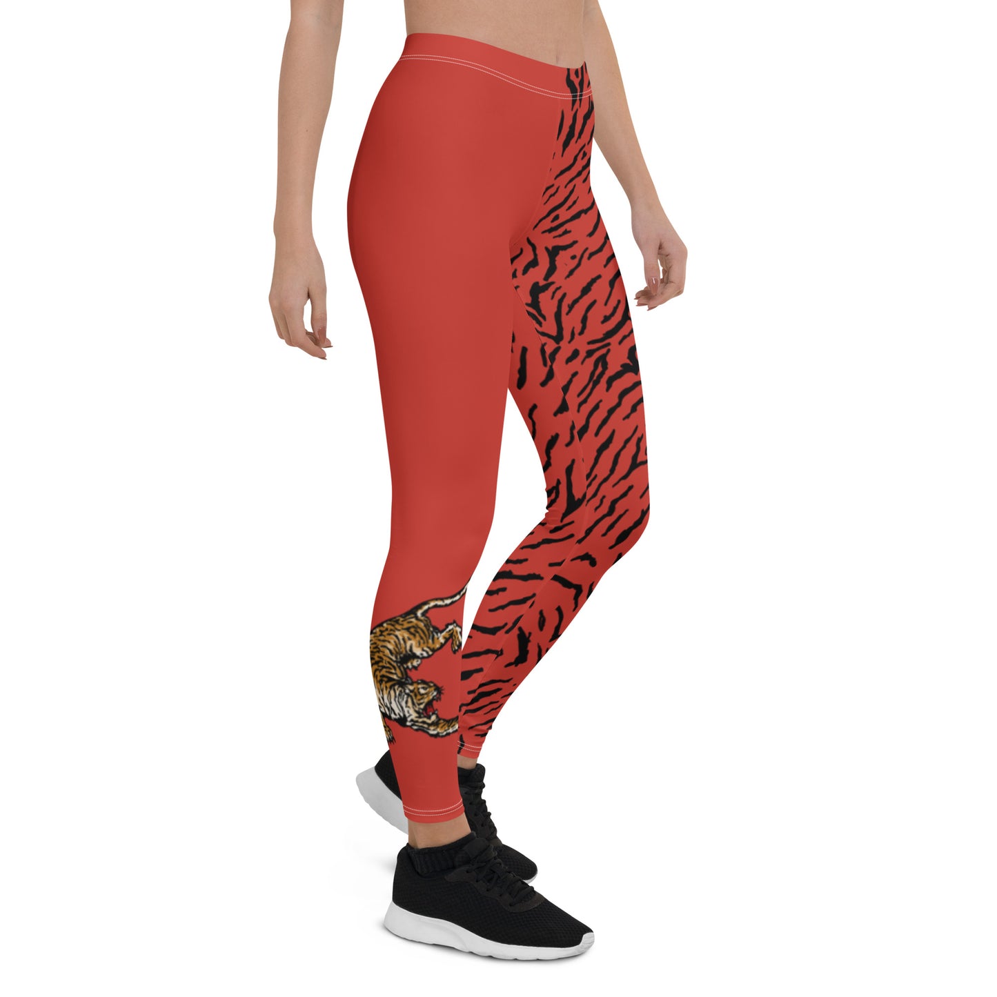 Female model wearing Red leggings with a hand drawn tiger on the right lower leg and black tiger print covers the left leg and waist fully on the left side, front and back.