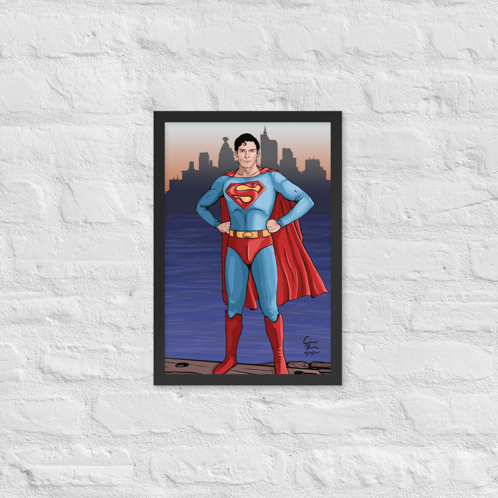 Semi realistic caricature of Christopher Reeve Superman standing on a dock with Metropolis in the background. The picture is framed with a black frame and is hanging on a white brick wall.