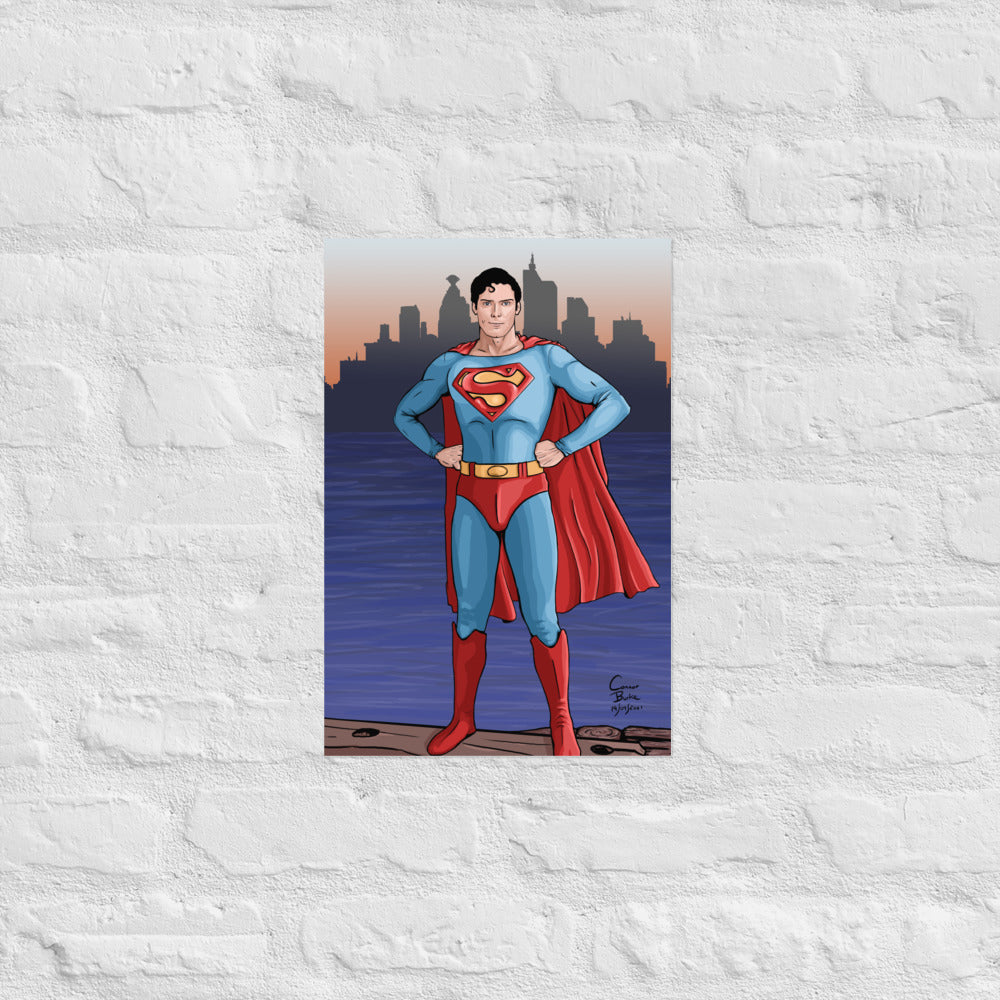 Semi realistic caricature of Christopher Reeve Superman standing on a dock with Metropolis in the background. The print is hanging on a white brick wall.