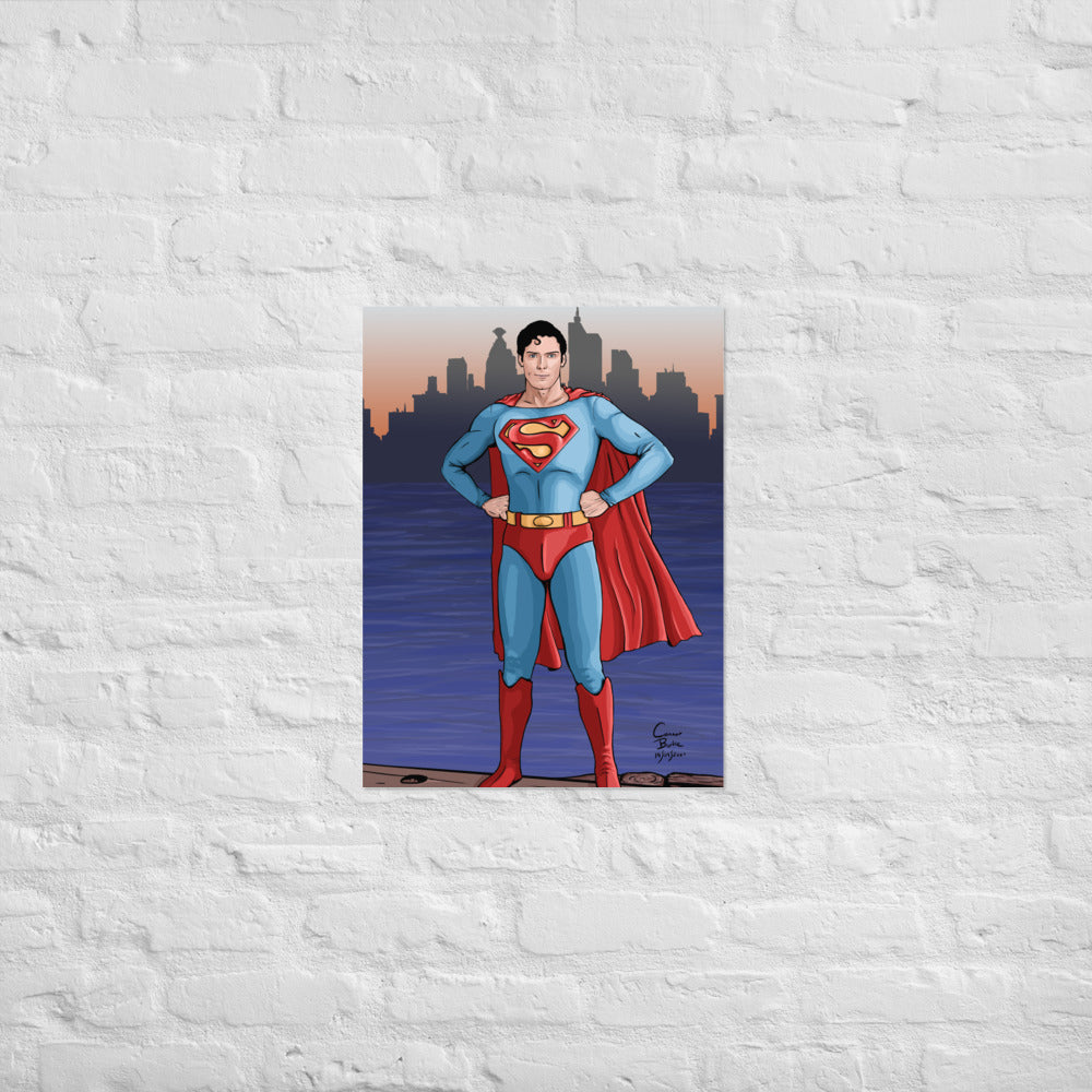 Semi realistic caricature of Christopher Reeve Superman standing on a dock with Metropolis in the background. The print is hanging on a white brick wall.