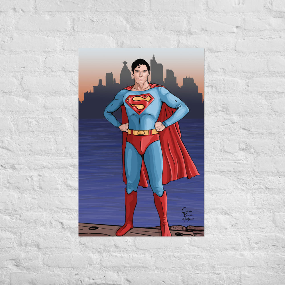 Semi realistic caricature of Christopher Reeve Superman standing on a dock with Metropolis in the background. The print is hanging on a white brick wall.